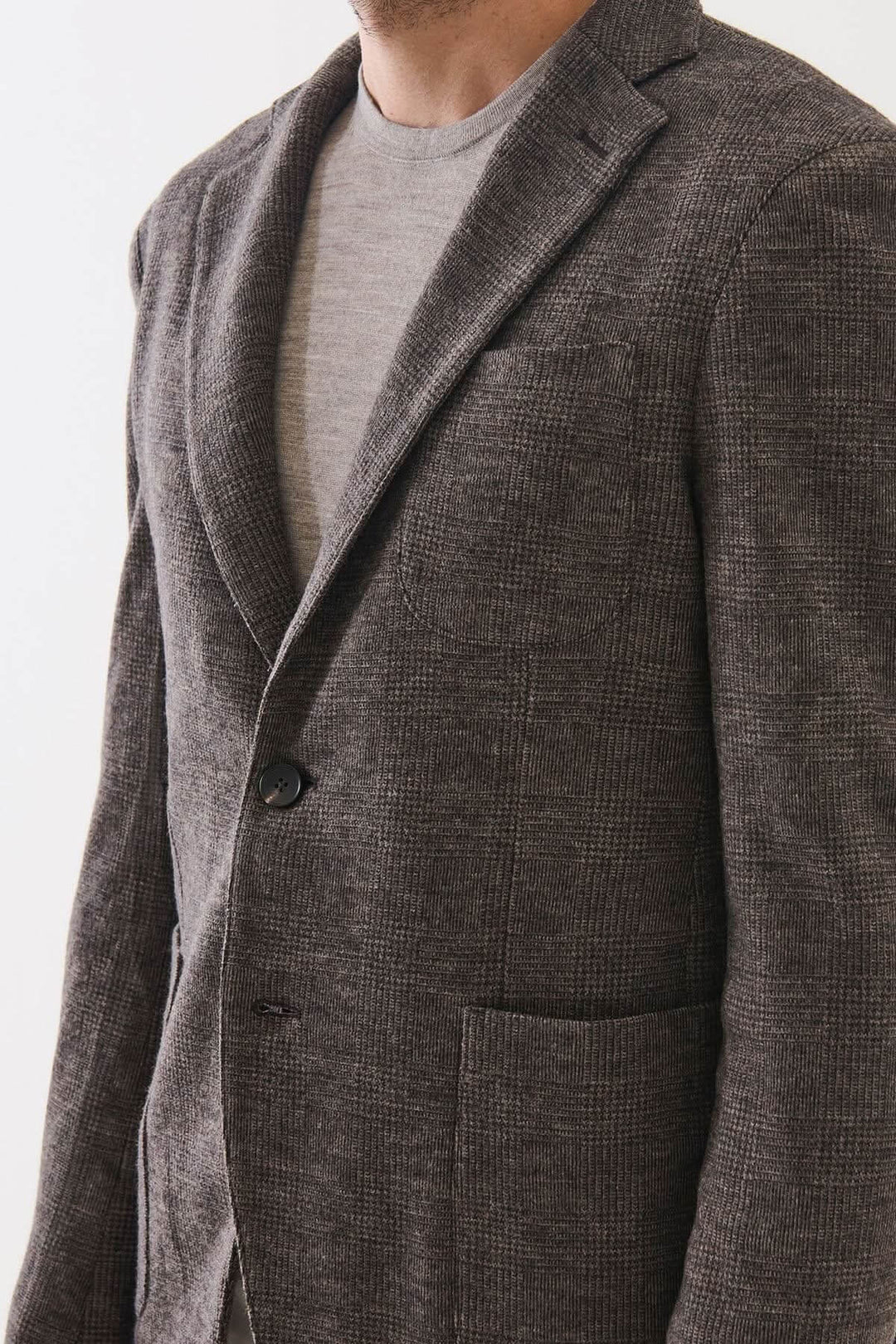 Blazer à deux boutons en laine à carreaux déstructuré pour homme, motif prince-de-galles, confection italienne, look élégant et décontracté.