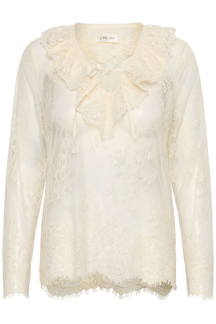 Blouse Mira en dentelle transparente à manches longues avec col décoratif et lien à nouer, élégante et féminine.