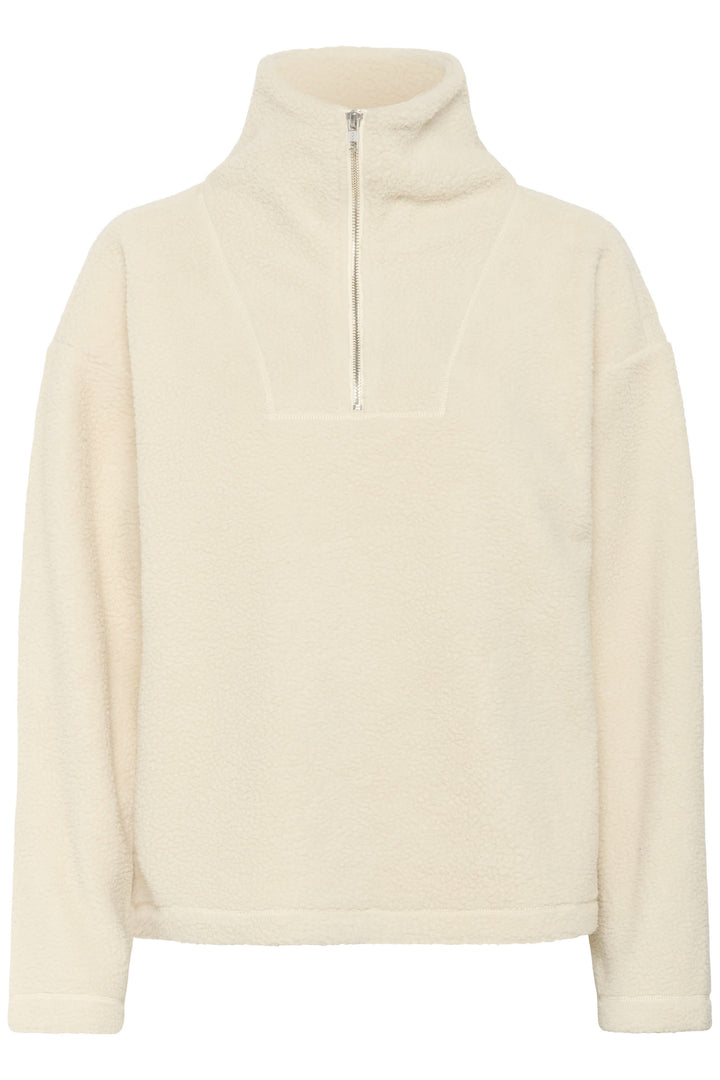 Chandail Sirana en tissu sherpa avec col montant zippé, idéal pour la mi-saison. Coupe ample et confortable pour un style cosy.