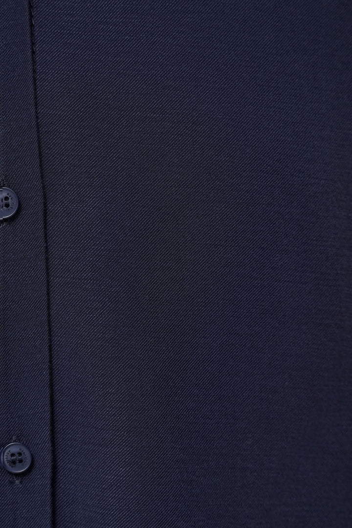 Détail de tissu bleu marine de chemise fluide avec boutons, élégante et confortable.