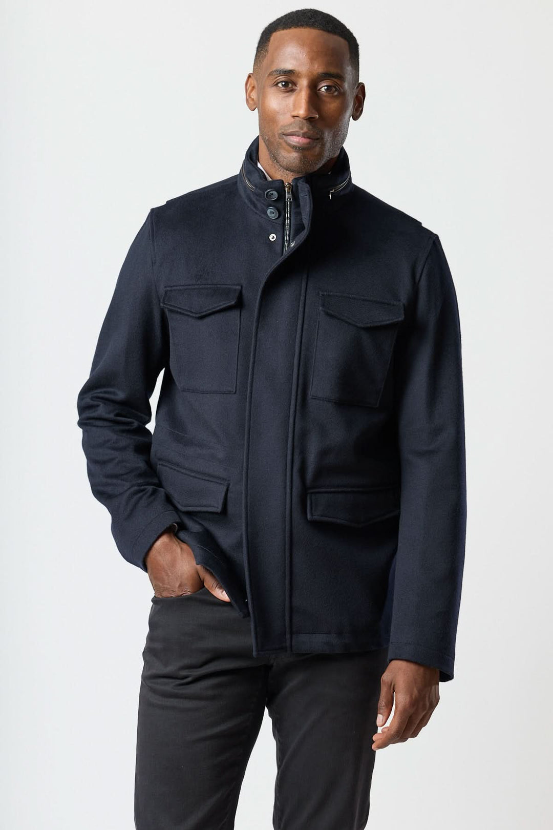 Homme portant un manteau en laine à quatre poches avec col montant et détails smart-casual, inspiré du field jacket.