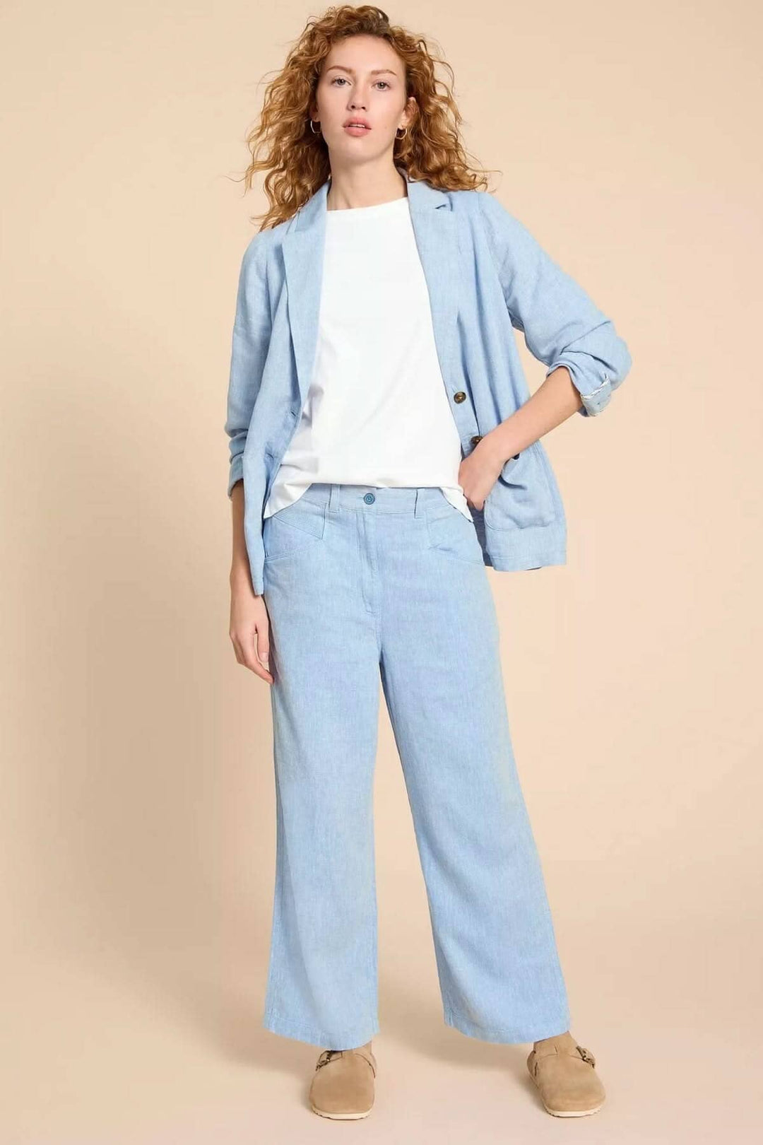 Pantalon Harper à jambe large, chic et élégant, porté avec un blazer, parfait pour un look décontracté.