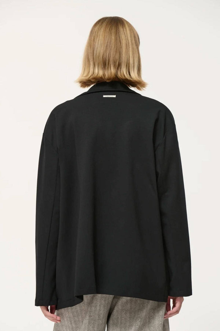 Veston Cayden noir, coupe droite et ample, vu de dos avec manches longues et emmanchures descendues.