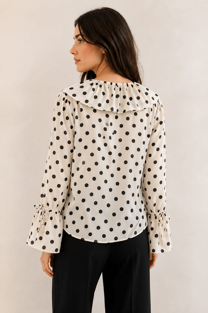 Front view of a black polka-dot collarless blouse with a ruffled collar Oui for women - Valérie Simon
