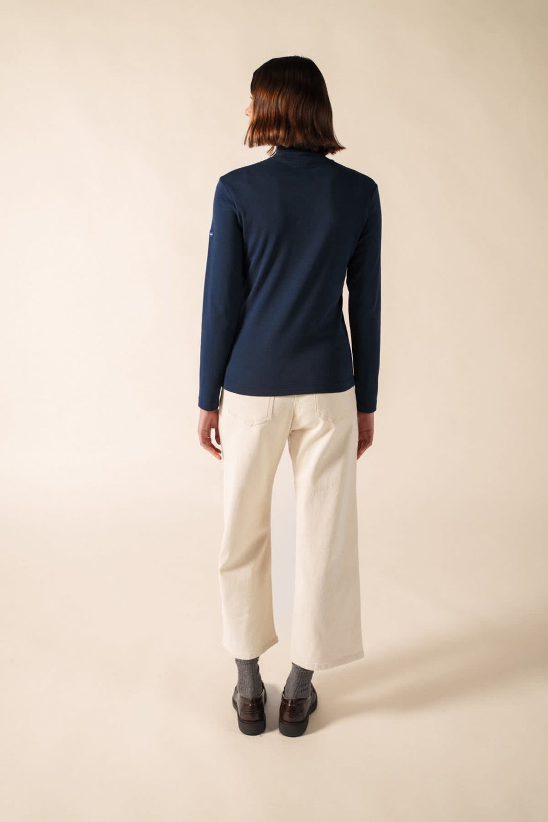 Side view of the blue Celina turtleneck navy for women by Saint James, as worn by Valérie Simon