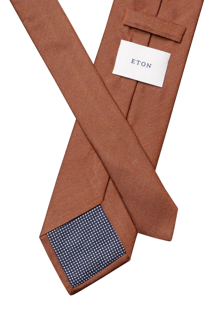 Side view of a solid-color red Eton silk tie for men - Valérie Simon