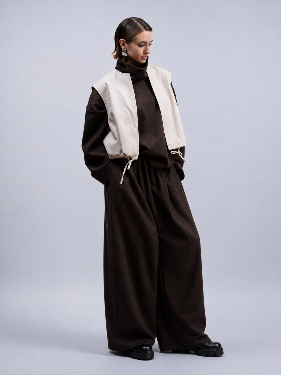 Side view of the Haako black faux leather sleeveless jacket for women - Valérie Simon