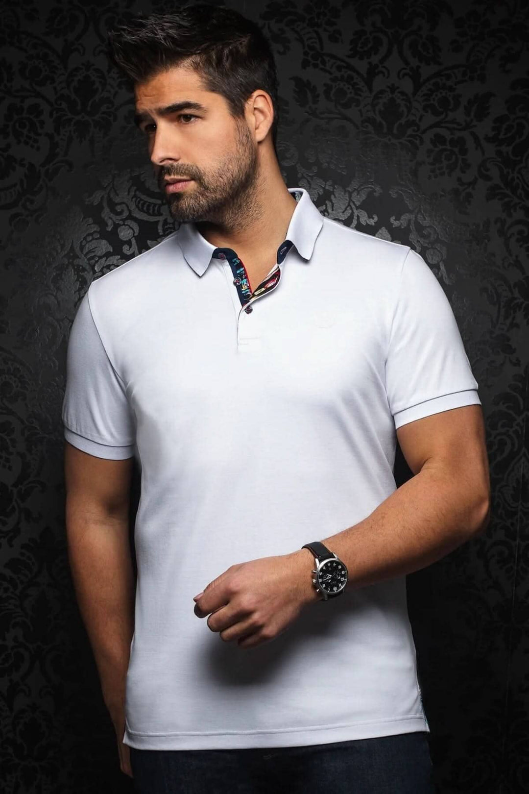 Homme portant un polo blanc au design élégant, col contrastant et détails colorés, parfait pour un look décontracté.