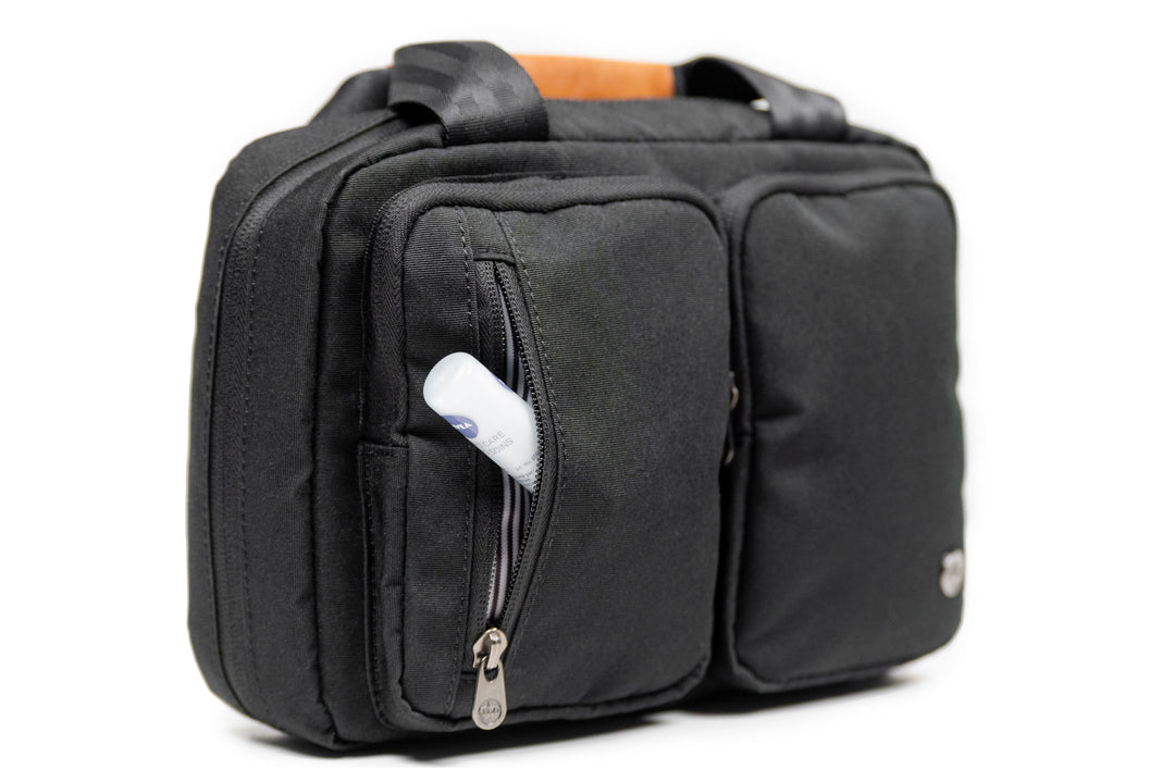 PKG Simcoe recycled essentials bag with multiple pockets and vegan leather accents, perfect for toiletries organization.