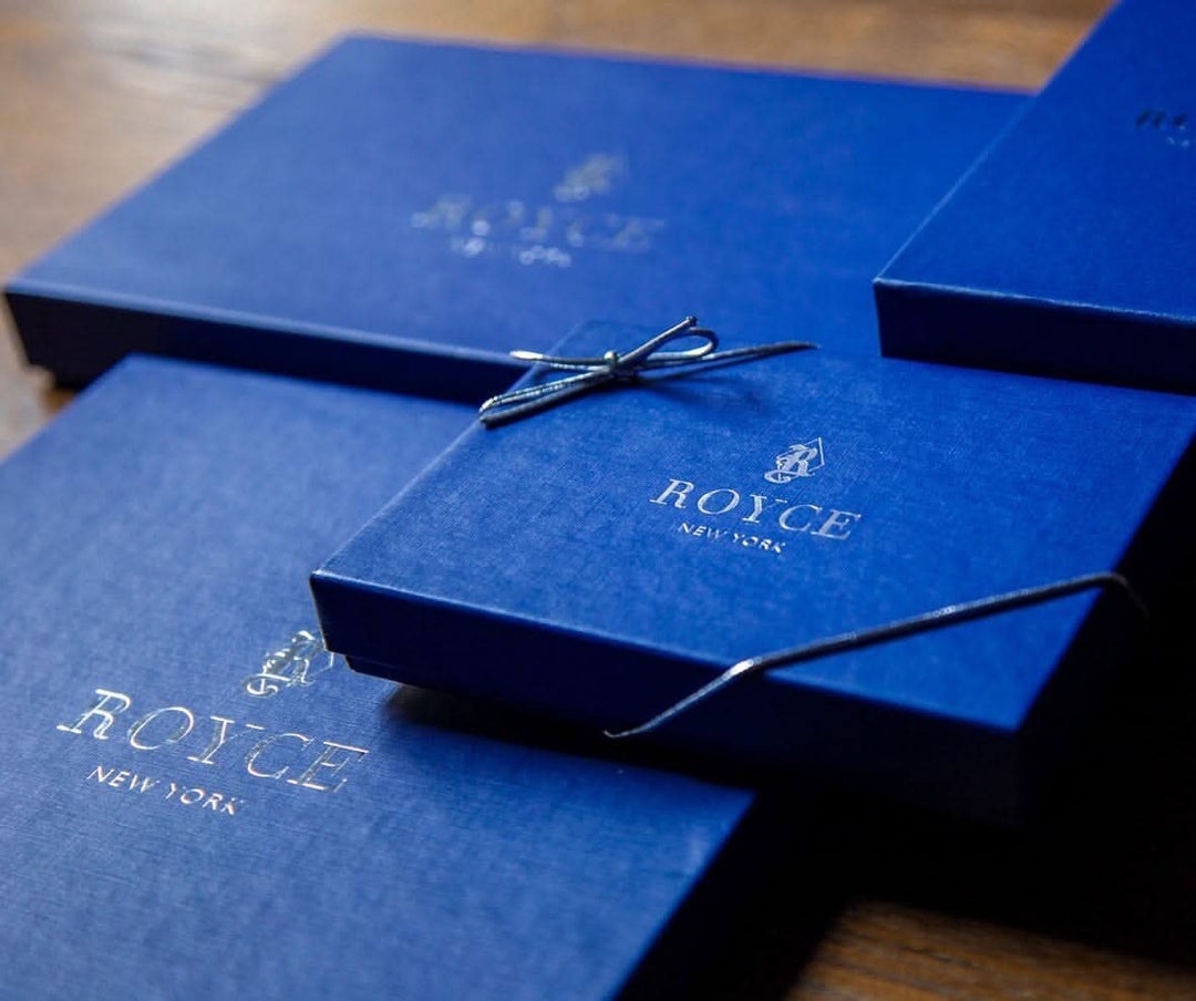 Elegant blue gift boxes with gold ROYCE New York branding, perfect for luxury card set packaging.